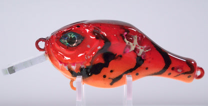 The Sinister Squarebill in Fire Craw is a 0.7 oz shallow-diving crankbait designed to bring the heat when bass are feeding on crawfish. Diving 3 to 5 feet, this lure excels around rock, wood, and shallow structure where big fish hunt. The Fire Craw color pattern combines deep reds, burnt orange, and black accents to perfectly imitate a defensive crawfish — irresistible to pre-spawn and early spring bass.

Built with a squarebill design for a bold, erratic deflection, that crashes through cover.